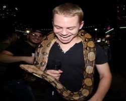 He is a brave person and isn't afraid to hold a python.